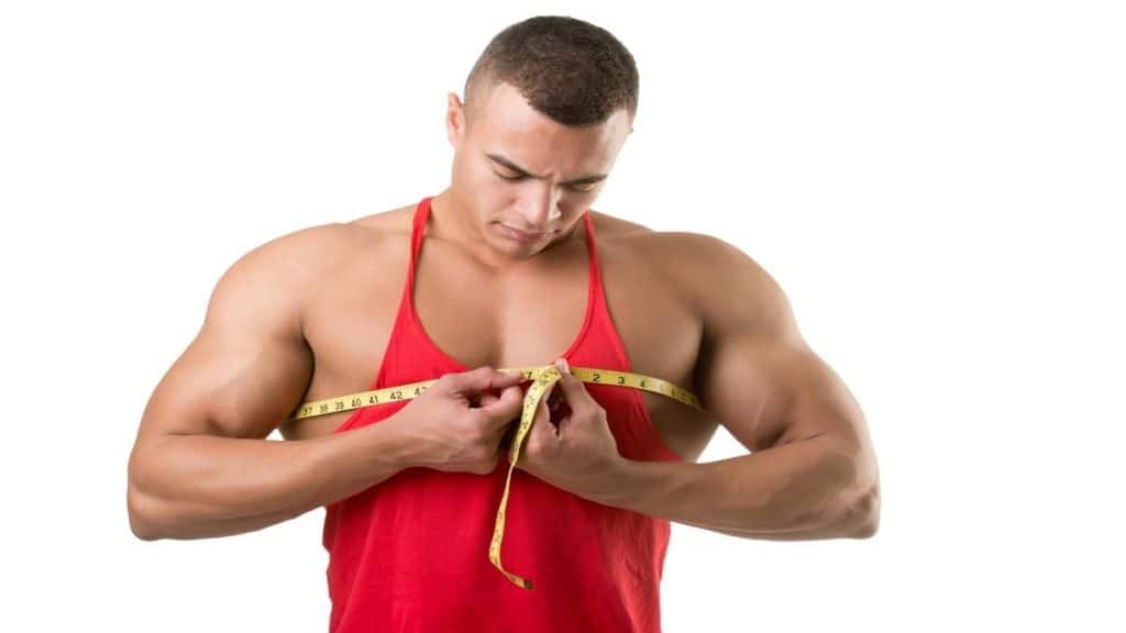 A bodybuilder measuring his big 45 inch chest