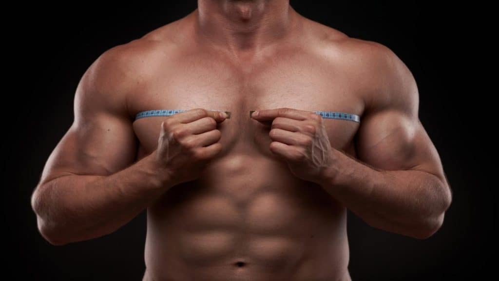 A man measuring his big 46 inch chest
