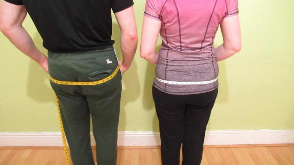 A man and a woman showing that they have a normal hip size