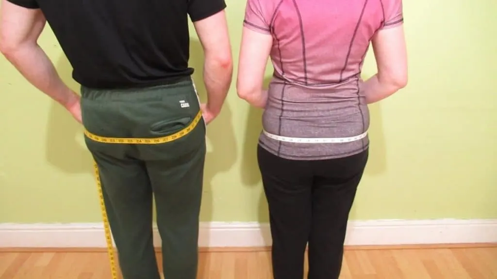 A man and a woman showing that they have a normal hip size