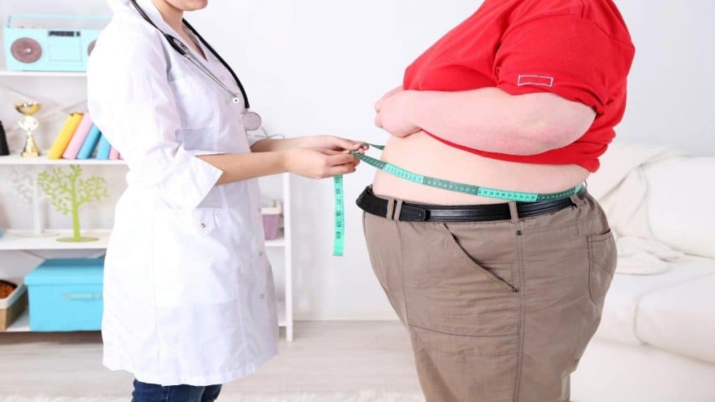 An obese man being examined by a doctor