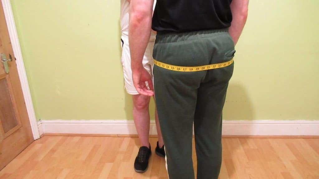 A man showing where to measure your hips