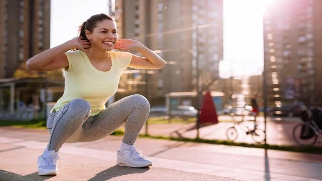 A woman doing squats outside