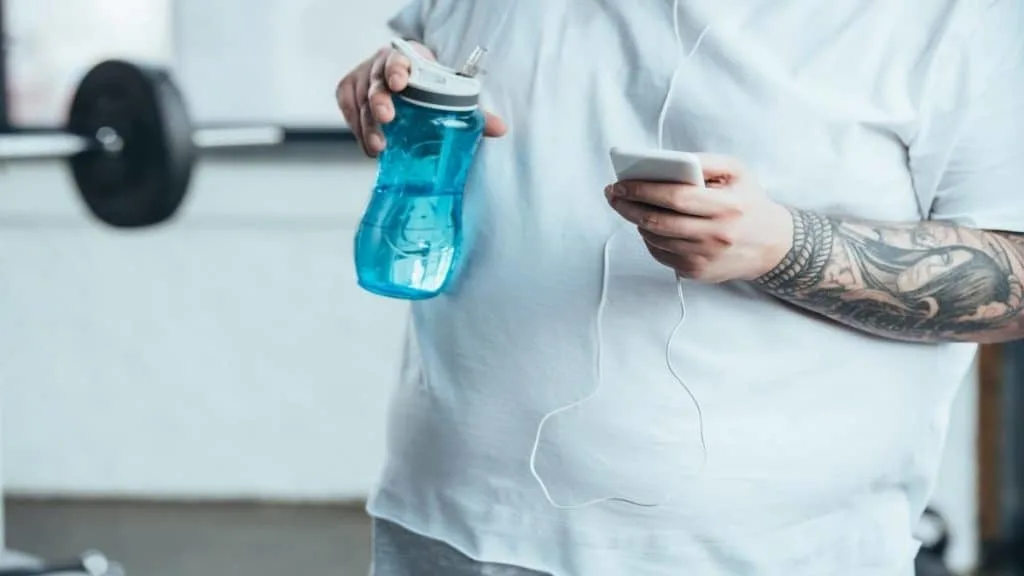 A man with 10 inch wrists holding a phone