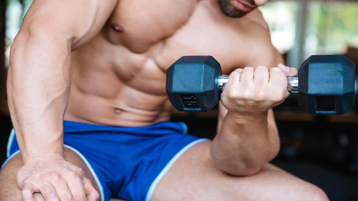 A man with a 10 inch wrist lifting weights