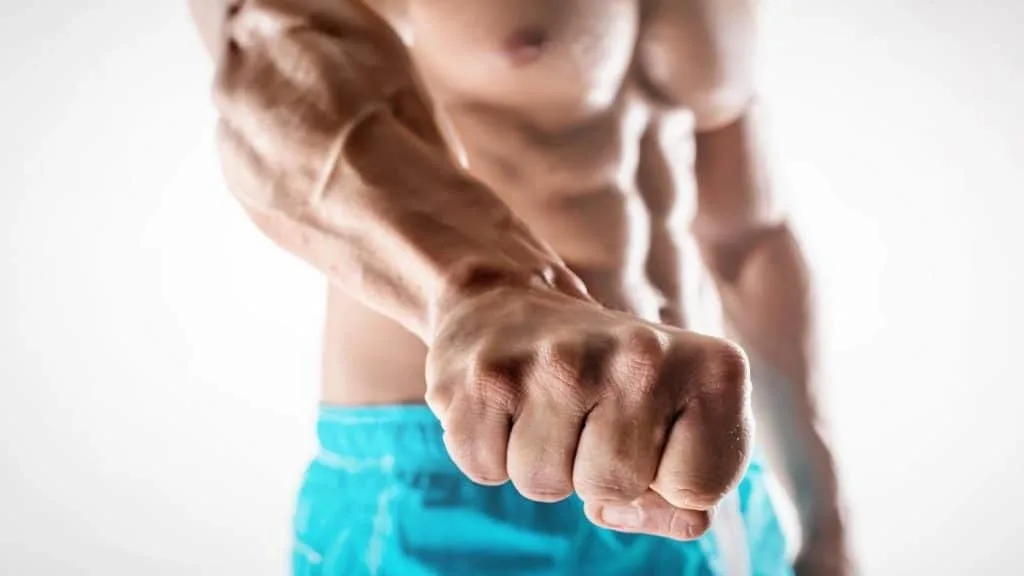 A bodybuilder showing his 8 inch wrist to the camera