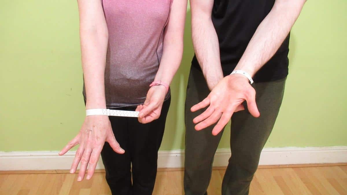 A woman demonstrating the average female wrist size by height