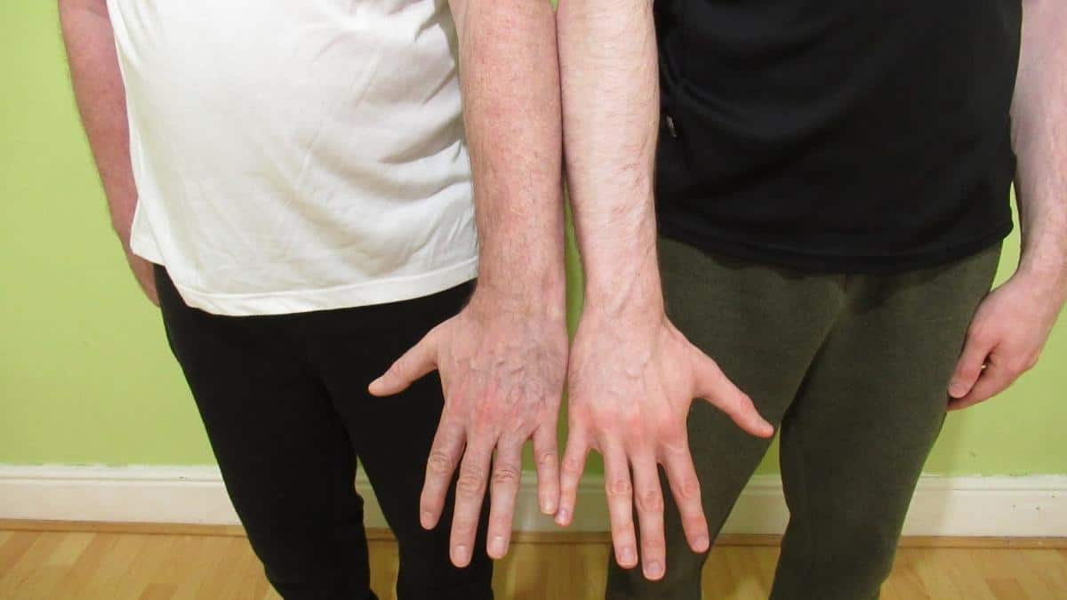 Two men demonstrating the average male wrist size by height