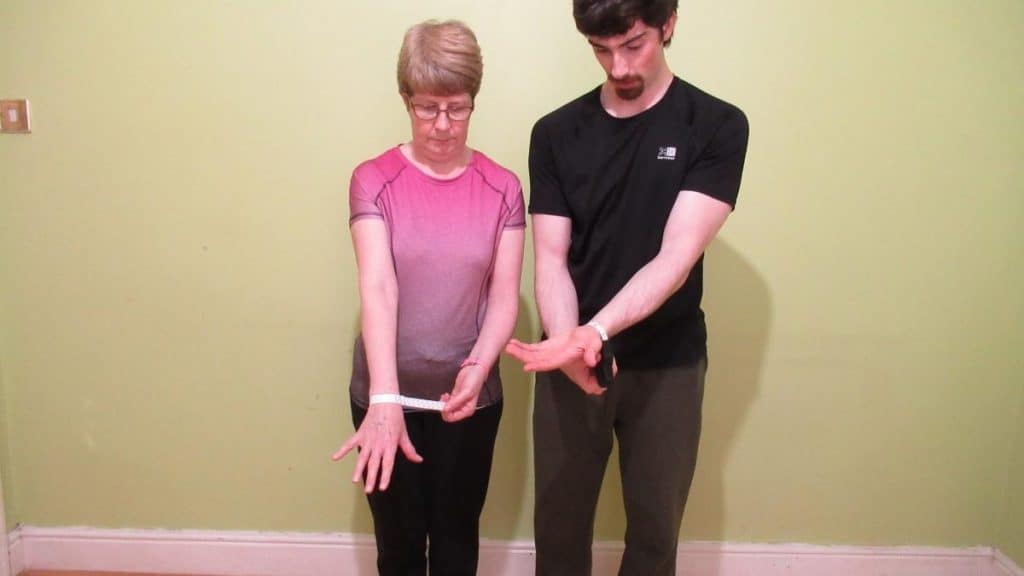 A man and a woman demonstrating the average wrist size by age