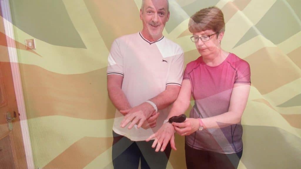 A British man and woman measuring their wrists to see if they have an average wrist size for UK residents