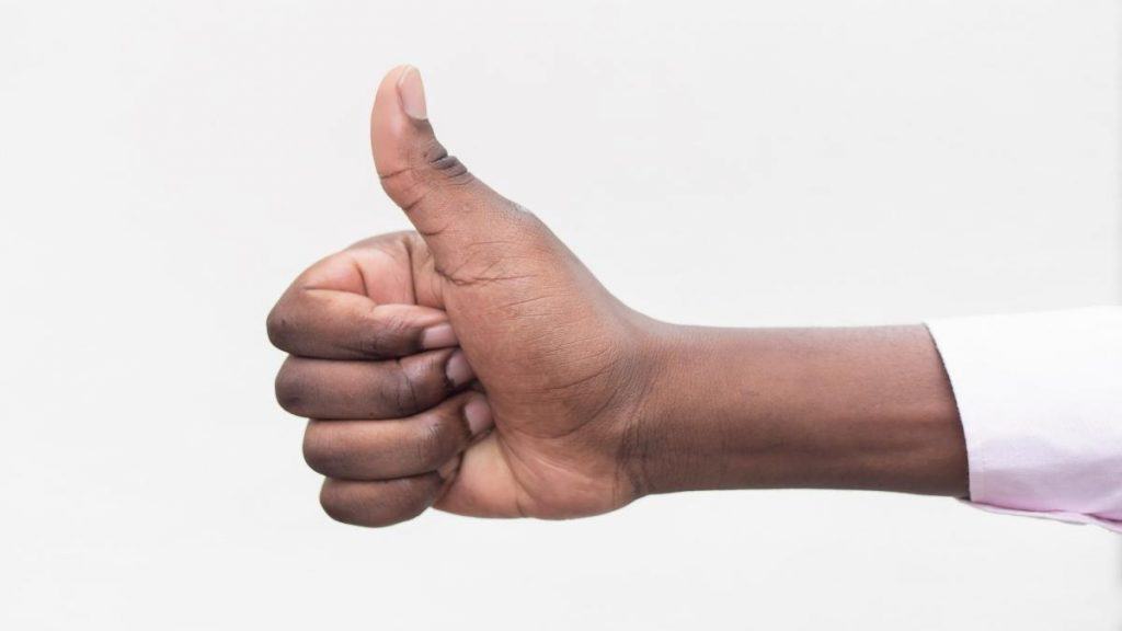 A person showing their small 5.5 inch wrist