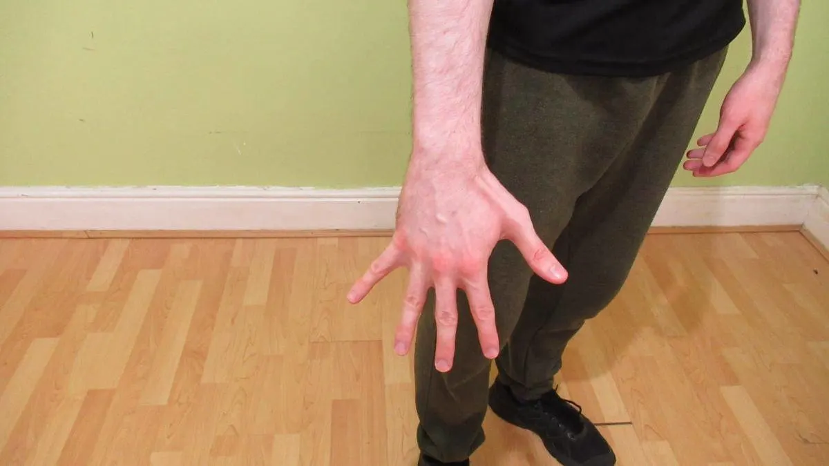 A man showing how big his 7 inch wrist is