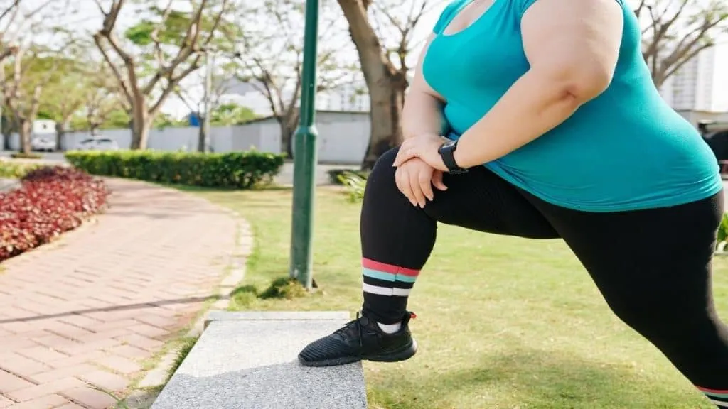 A woman showing that she has a 12 inch ankle