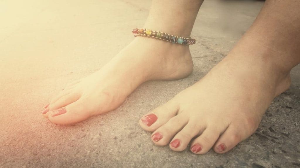 A woman showing the average length of an anklet