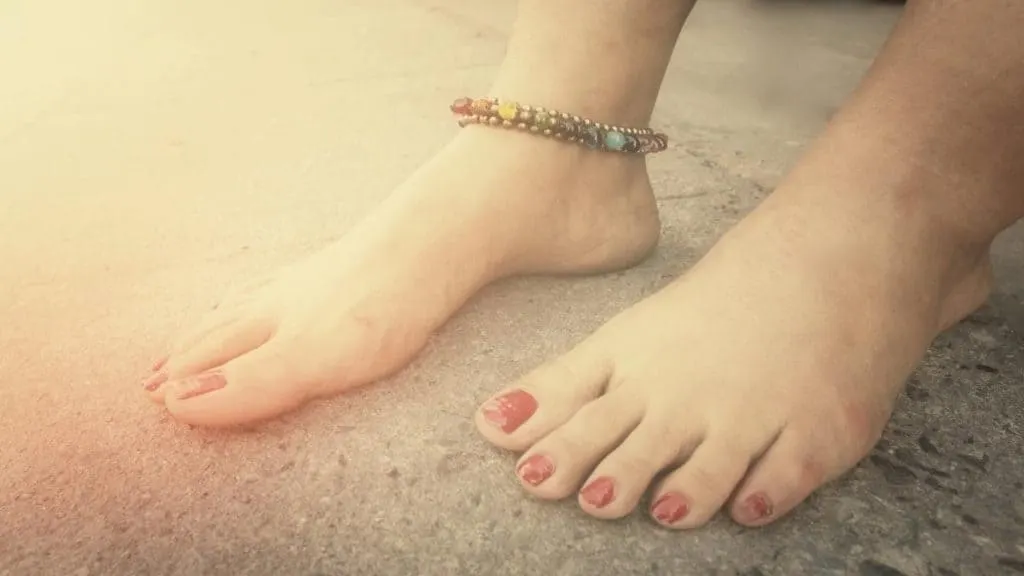 A woman showing the average length of an anklet