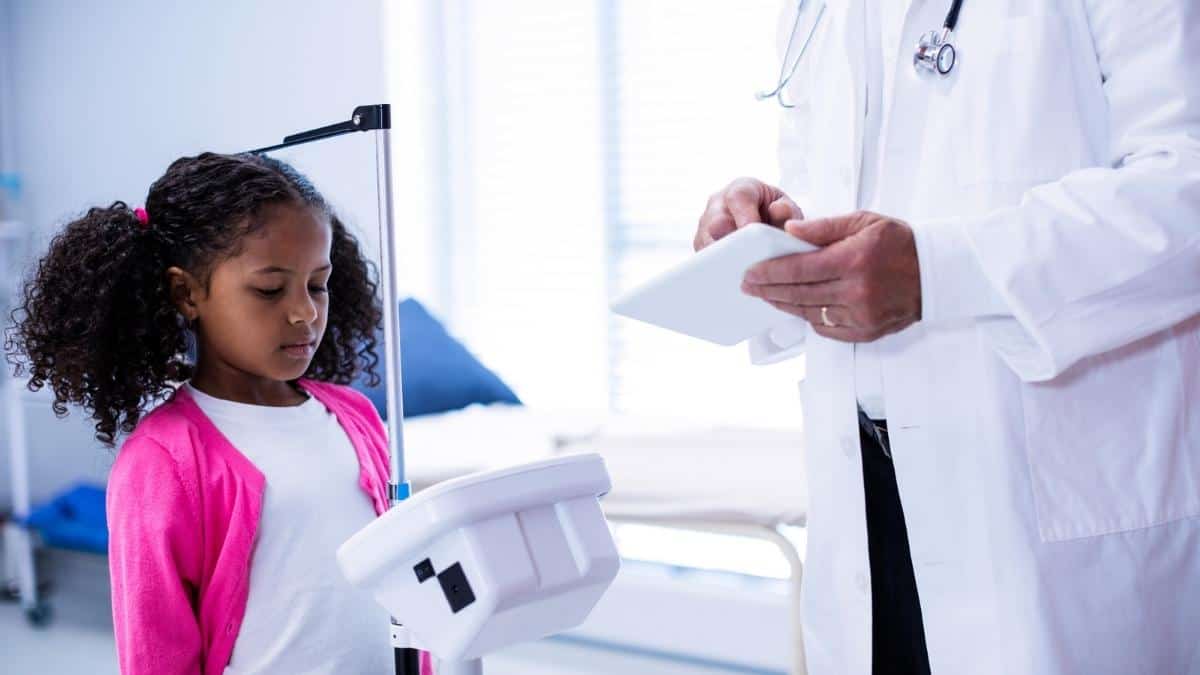 A girl being measured to see if she has an average 6th grader height