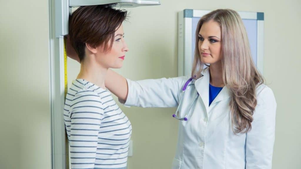 A woman being measured with a stadiometer