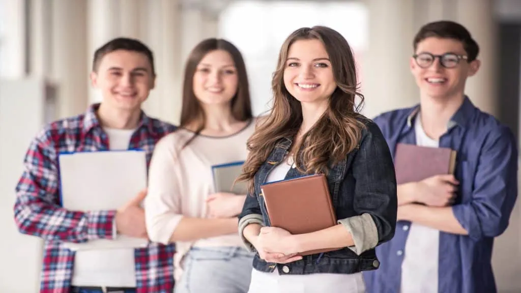 Some freshmen students holding their books