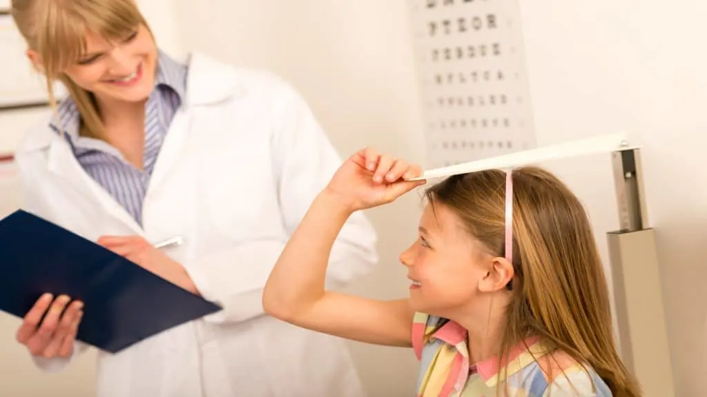 A girl getting her height measured