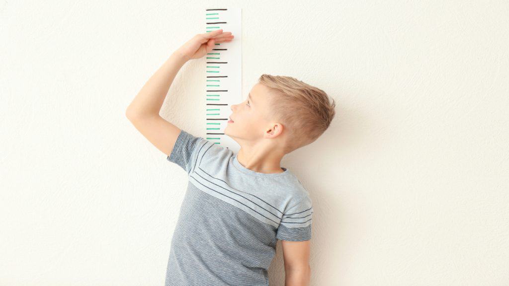 A boy demonstrating how to get taller at 11 years old