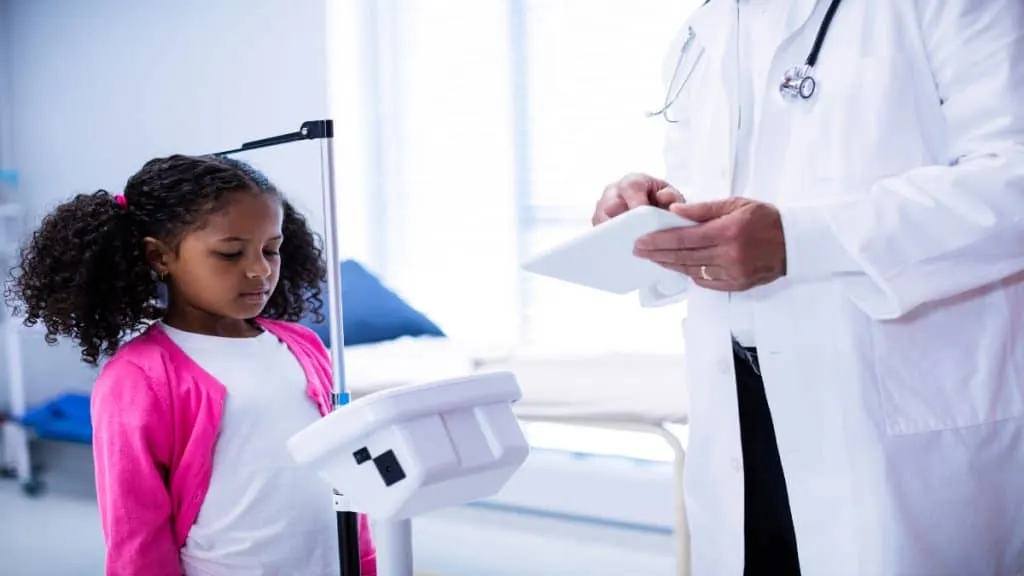 A doctor showing a girl how to grow taller at 14 years old