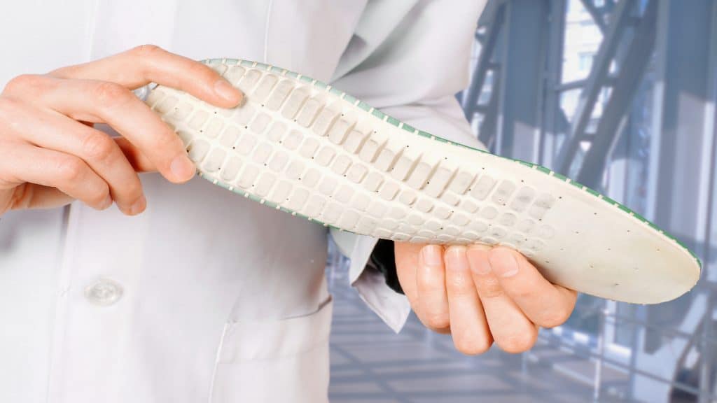 A person holding some insoles