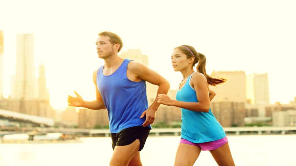 A man and a woman jogging in the city