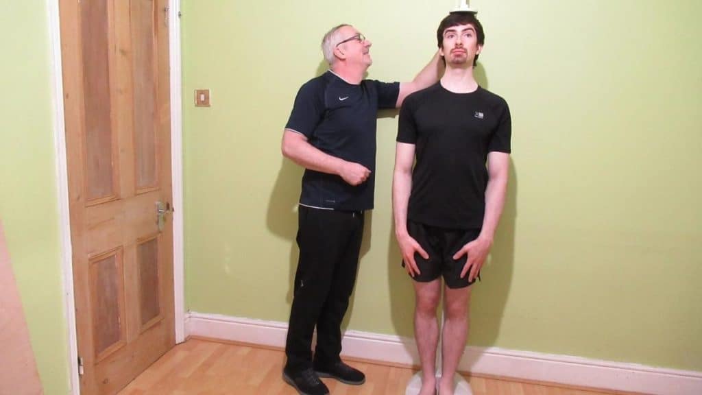 A man getting his height measured