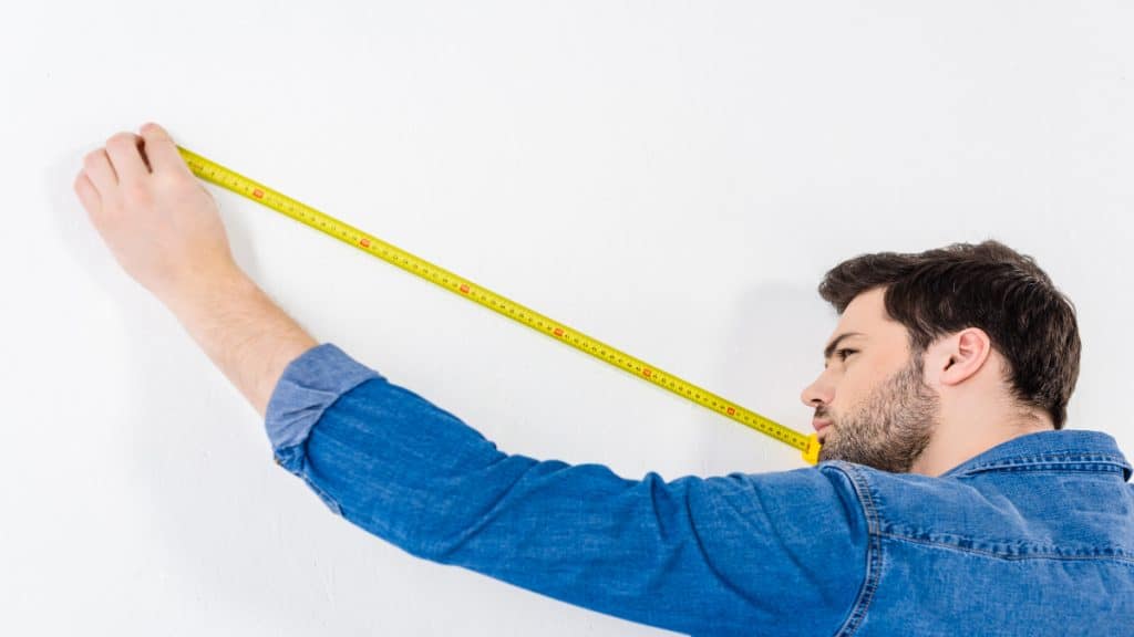 A man holding a measuring tape