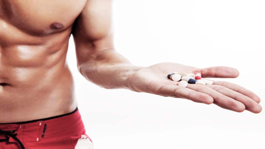 A man holding some supplements in his hand