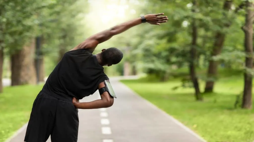 A man stretching his body outside