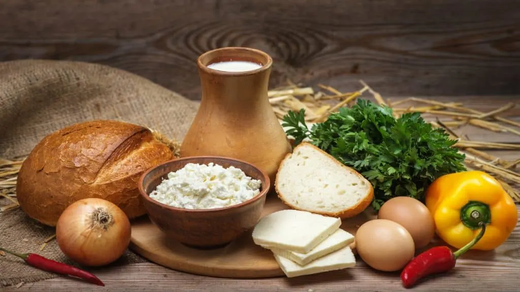 A selection of healthy foods including bread, milk, and vegetables