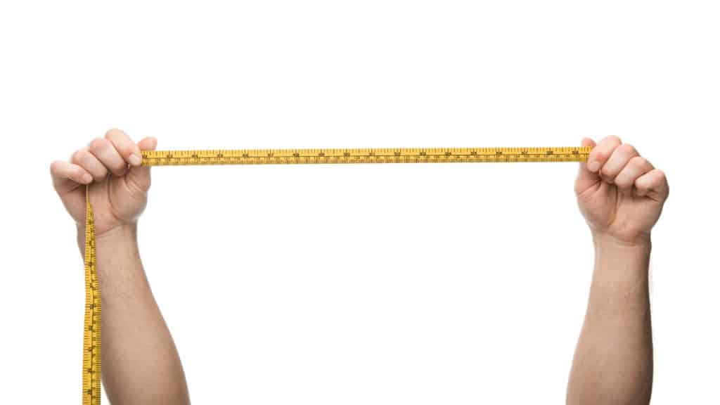 A person holding a measuring tape