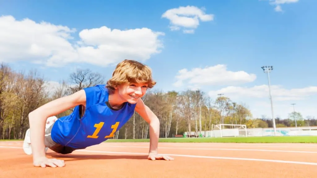 A teenage boy doing push ups