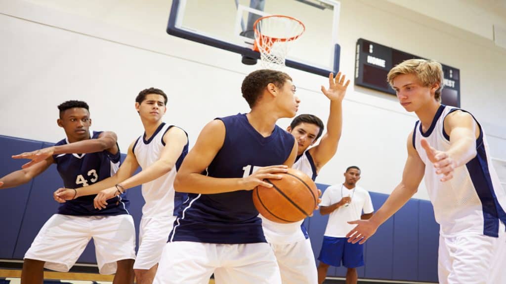 A group of teenagers playing basketball