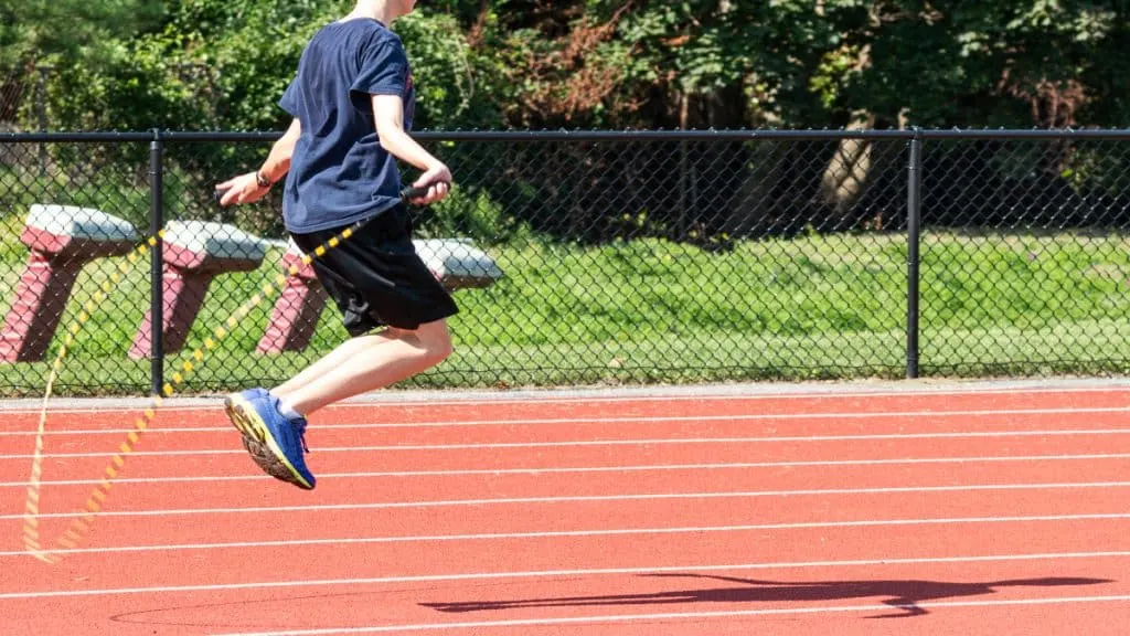 A boy skipping outside