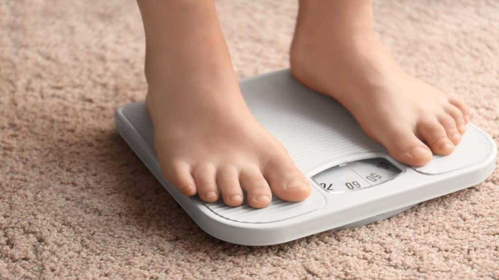 A person stood on some weighing scales
