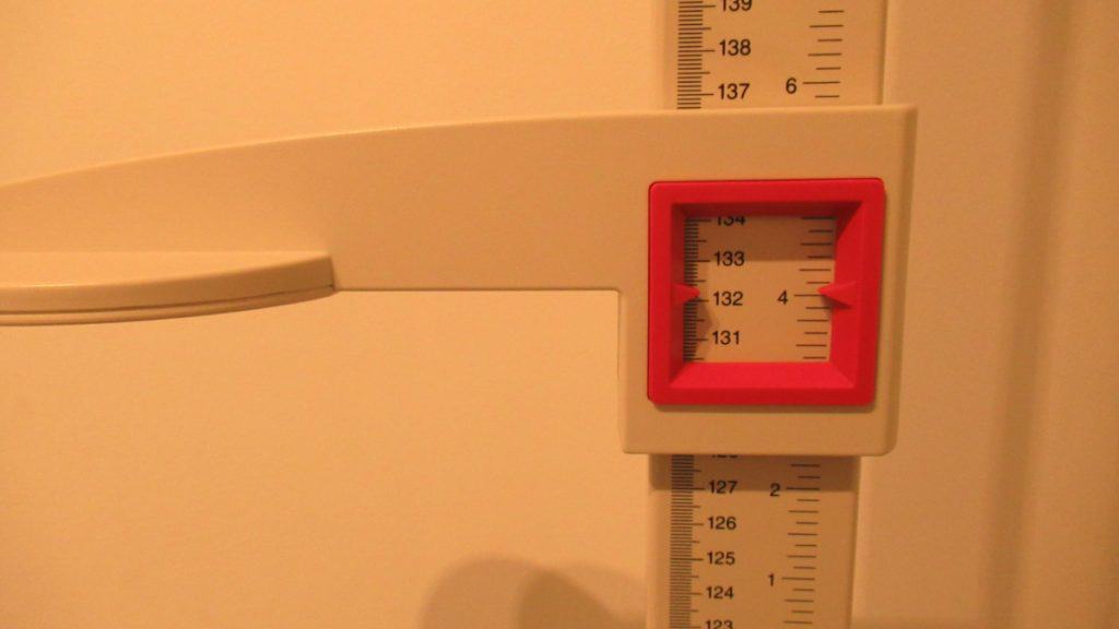 A stadiometer displaying the height 4 feet 4 inches