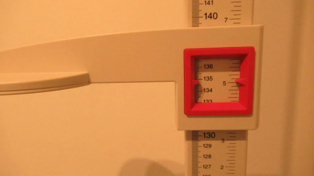 A stadiometer displaying the height 4 feet 5 inches