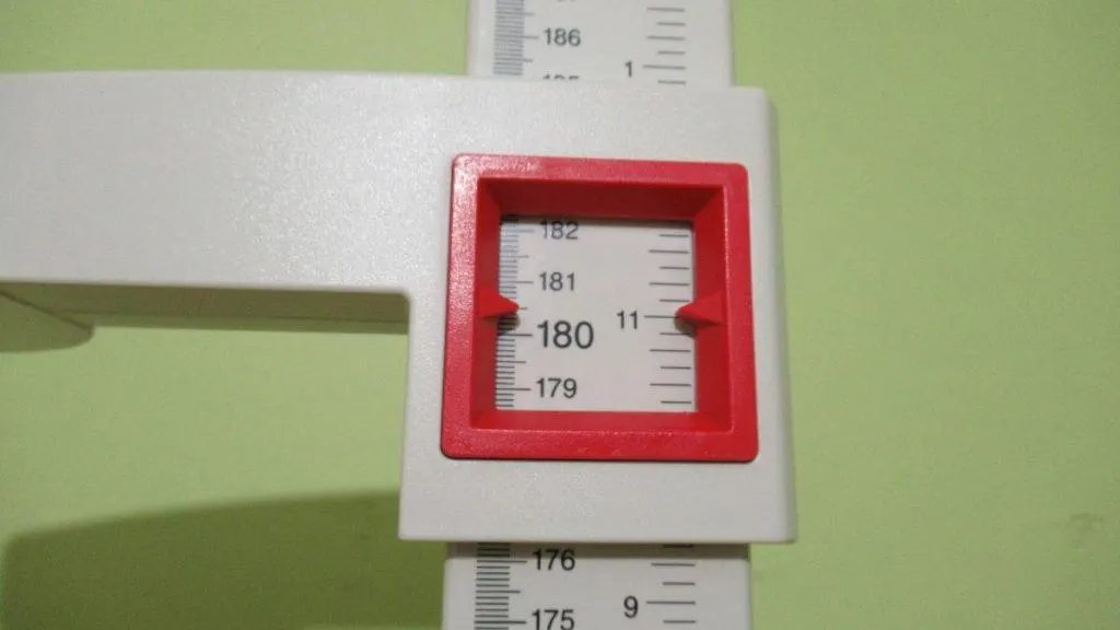 A stadiometer displaying the height 5 feet 11 inches