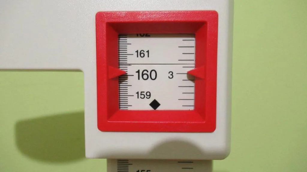 A stadiometer displaying the height 5 feet 3 inches