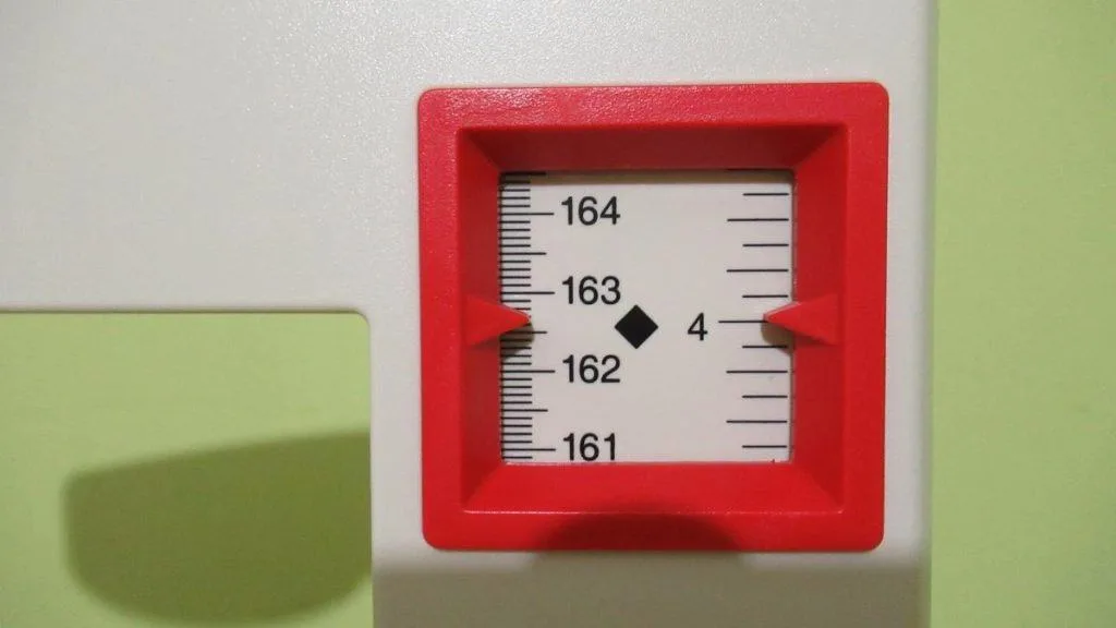 A stadiometer displaying the height 5 feet 4 inches