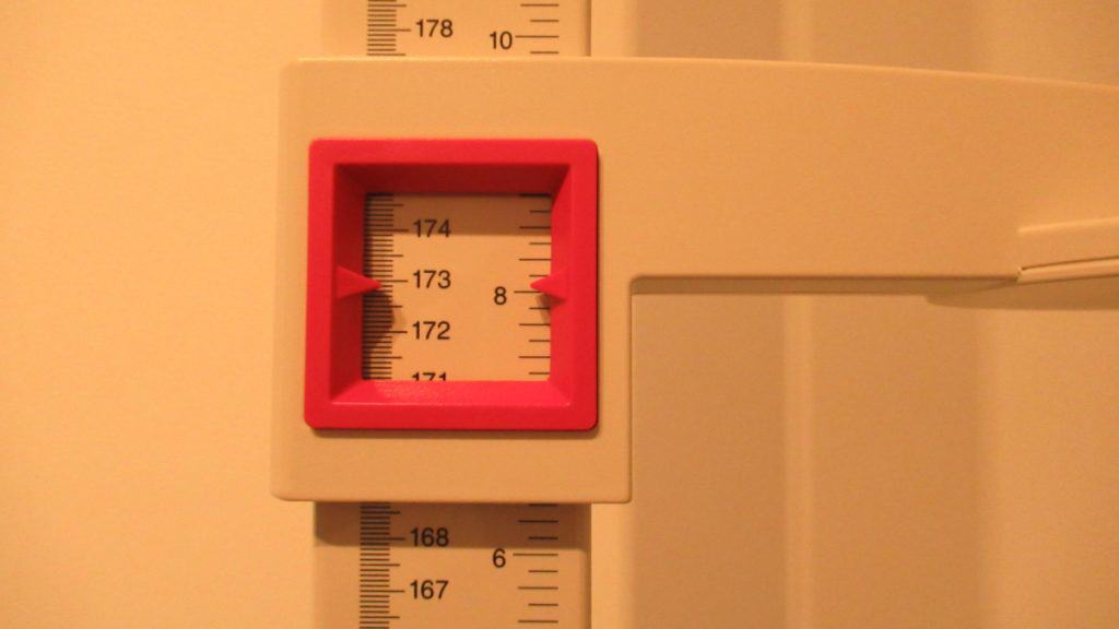 A stadiometer displaying the height 5 feet 8 inches