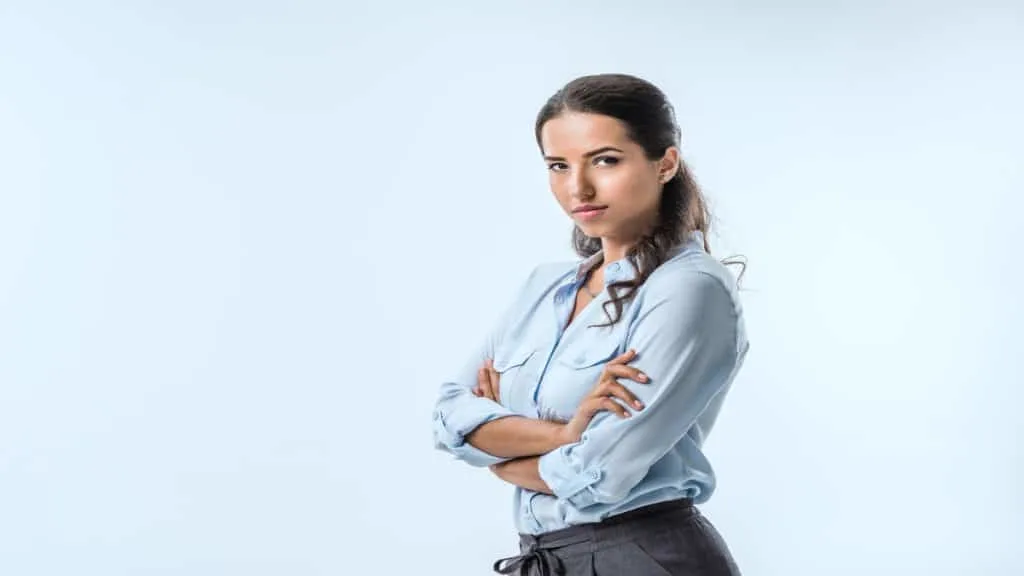 A confident woman standing with her arms crossed