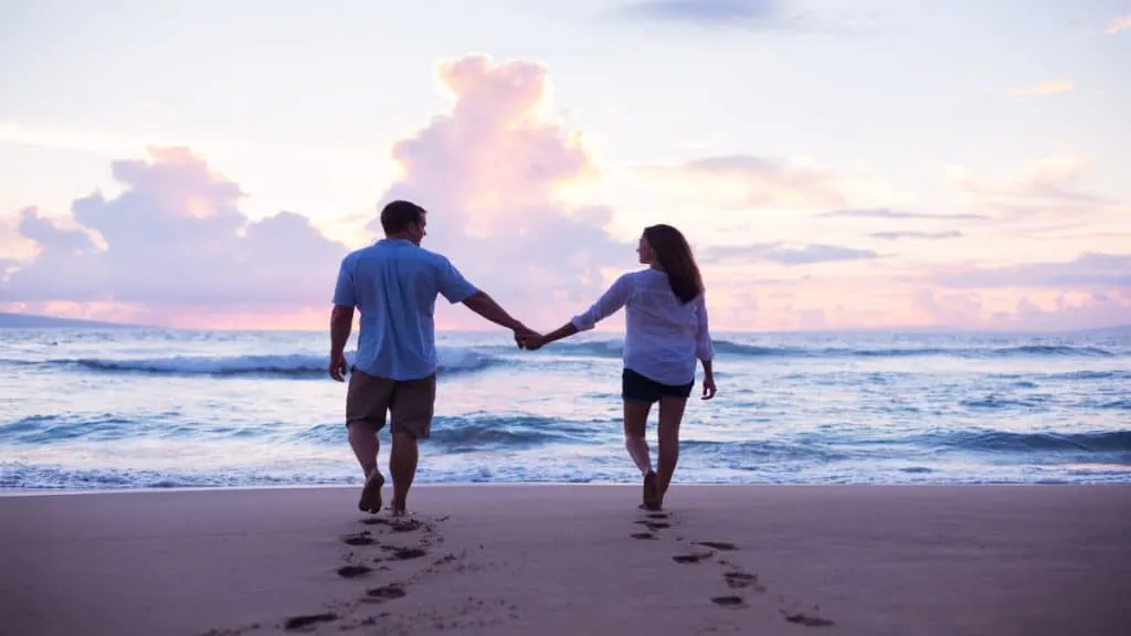 A couple holding hands at the beach