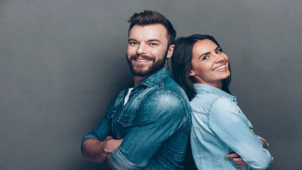 A man and a woman standing back to back