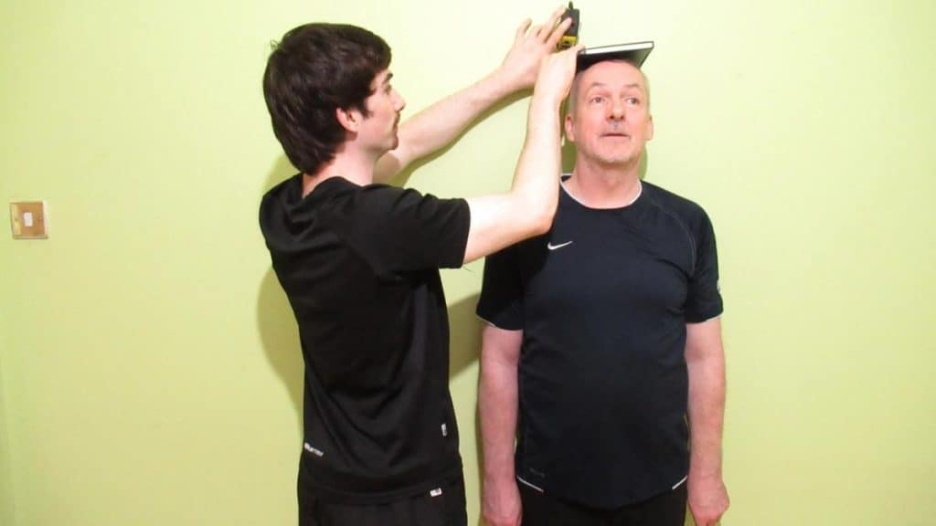 A man getting his height measured