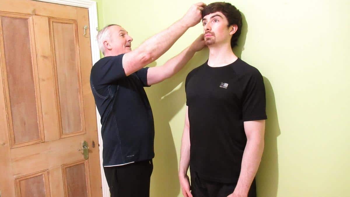 A tall 6'1 guy getting his height measured