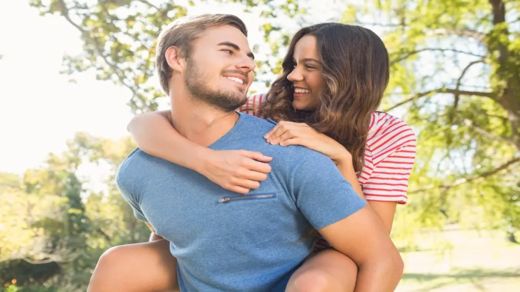 A man giving his girlfriend a piggyback