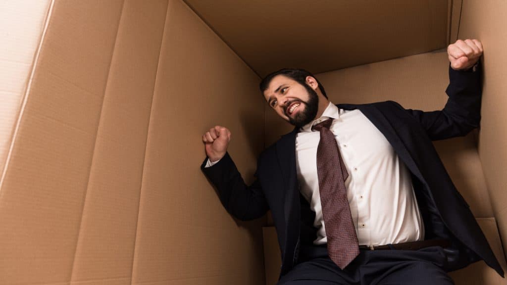 A man stuck inside a cardboard box